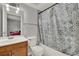 A cozy bathroom showcases a tiled shower with a decorative curtain at 1940 S Conway Rd # 8, Orlando, FL 32812