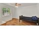 This simple bedroom features hardwood floors and a large window at 1940 S Conway Rd # 8, Orlando, FL 32812