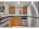 Functional kitchen with stainless steel appliances and wood cabinets at 1940 S Conway Rd # 8, Orlando, FL 32812