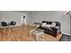 Inviting living room with hardwood floors, modern furniture, and a dining area at 1940 S Conway Rd # 8, Orlando, FL 32812