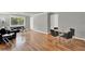 Open-concept living room with hardwood floors, dining area, and large window at 1940 S Conway Rd # 8, Orlando, FL 32812