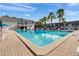 Beautiful community pool surrounded by palm trees and lounge chairs at 1940 S Conway Rd # 8, Orlando, FL 32812