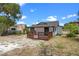 Exterior shot of house from backyard showing wooden deck at 209 N 14Th St, Leesburg, FL 34748