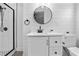 Modern bathroom with new vanity, round mirror, shiplap accent wall, and glass shower at 209 N 14Th St, Leesburg, FL 34748