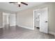 Spacious bedroom featuring modern flooring and doors leading to the ensuite bathroom at 209 N 14Th St, Leesburg, FL 34748