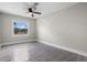 Bright bedroom features tile floors, a modern ceiling fan and a large window at 209 N 14Th St, Leesburg, FL 34748