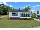 Charming renovated bungalow featuring black and white exterior paint and new windows at 209 N 14Th St, Leesburg, FL 34748