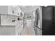 Remodeled kitchen showcasing stainless steel appliances, long counters, and open floorplan at 209 N 14Th St, Leesburg, FL 34748