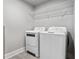 Convenient laundry room with washer, dryer, and storage shelf at 209 N 14Th St, Leesburg, FL 34748