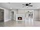 Bright living room features tile floors, a modern ceiling fan, fire place, and multiple entry ways at 209 N 14Th St, Leesburg, FL 34748