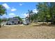Spacious yard featuring a charming home with a wooden deck, providing ample outdoor space at 209 N 14Th St, Leesburg, FL 34748