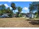 Lush yard showcasing a charming home with a welcoming wooden deck for outdoor living at 209 N 14Th St, Leesburg, FL 34748