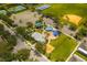 Aerial view of community amenities including a playground, parking, tennis courts, and baseball field at 2246 Florida Soapberry Blvd, Orlando, FL 32828