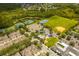 The aerial view highlights the community's amenities, including tennis courts, a playground, and a baseball field at 2246 Florida Soapberry Blvd, Orlando, FL 32828