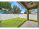 View of a fenced-in backyard, featuring well-maintained grass and a concrete patio for outdoor enjoyment at 2246 Florida Soapberry Blvd, Orlando, FL 32828