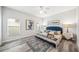 Bright bedroom featuring luxury vinyl floors, a ceiling fan, and an upholstered blue headboard at 2246 Florida Soapberry Blvd, Orlando, FL 32828