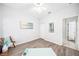 Bright bedroom features neutral walls, wood-look floors, and ceiling fan providing a calm and inviting space at 2246 Florida Soapberry Blvd, Orlando, FL 32828