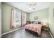 Cozy bedroom with decorative drapes, a ceiling fan, and luxury vinyl plank flooring at 2246 Florida Soapberry Blvd, Orlando, FL 32828