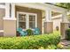 Cozy front porch seating, with an inviting spot to relax, framed by lush landscaping at 2246 Florida Soapberry Blvd, Orlando, FL 32828