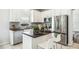 Bright kitchen features stainless steel appliances, white cabinetry and tile backsplash at 2246 Florida Soapberry Blvd, Orlando, FL 32828