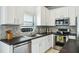Well-equipped kitchen with stainless steel appliances, white cabinets, and modern countertops at 2246 Florida Soapberry Blvd, Orlando, FL 32828