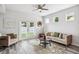 Well-lit living room features modern furniture, stylish decor, and hardwood style floors at 2246 Florida Soapberry Blvd, Orlando, FL 32828