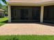 Covered back porch with a brick patio and screen enclosure at 2258 Rickover Pl, Winter Garden, FL 34787