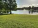 A lush backyard featuring a pond with a fountain on a sunny day at 2258 Rickover Pl, Winter Garden, FL 34787