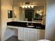 Bright bathroom with vanity, granite counters, large mirror, and decorative lighting at 2258 Rickover Pl, Winter Garden, FL 34787
