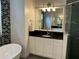 Bright bathroom with vanity, granite counters, glass shower, and decorative lighting at 2258 Rickover Pl, Winter Garden, FL 34787