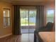Bedroom featuring calming lake views through sliding glass doors, enhanced by natural light and neutral decor at 2258 Rickover Pl, Winter Garden, FL 34787