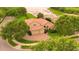 Stunning aerial view of a home with a red tile roof, a three-car garage, and lush landscaping at 2258 Rickover Pl, Winter Garden, FL 34787