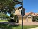 Street view of a two-story home boasting a three-car garage, red-tiled roof and manicured yard at 2258 Rickover Pl, Winter Garden, FL 34787
