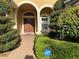 Covered front entrance with well-manicured landscaping and an ADT security sign at 2258 Rickover Pl, Winter Garden, FL 34787