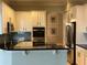 Modern kitchen with granite countertops, stainless steel appliances, and white cabinets at 2258 Rickover Pl, Winter Garden, FL 34787