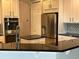 Modern kitchen with granite countertops, stainless steel appliances, and white cabinets at 2258 Rickover Pl, Winter Garden, FL 34787