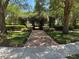 Beautifully landscaped walking path with manicured hedges and decorative planters creating an inviting outdoor space at 2258 Rickover Pl, Winter Garden, FL 34787