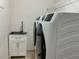 Convenient laundry room with modern appliances, a utility sink, and built-in shelving for organized storage at 2258 Rickover Pl, Winter Garden, FL 34787
