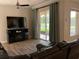 Comfortable living room with dark entertainment center and view to the backyard at 2258 Rickover Pl, Winter Garden, FL 34787