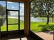 Relaxing outdoor patio with a screened enclosure and lovely views of the lush green lawn and glistening lake at 2258 Rickover Pl, Winter Garden, FL 34787