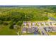 Aerial view of home with surrounding homes, pond, and green tree buffer in the back at 2335 Green Symphony Pl, Oviedo, FL 32765