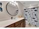 Bathroom with modern mirror, dark wood vanity and shower with shark themed curtain at 2335 Green Symphony Pl, Oviedo, FL 32765