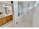 Tiled bathroom features double vanity, framed mirror, tile flooring, and shower with glass partition at 2335 Green Symphony Pl, Oviedo, FL 32765