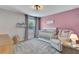 Cozy Bedroom with lavender accent wall, white crib and comfortable armchair at 2335 Green Symphony Pl, Oviedo, FL 32765
