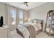 Bright bedroom features plush carpet, fan and decorative light fixture, and large windows with peaceful outdoor views at 2335 Green Symphony Pl, Oviedo, FL 32765