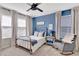 Bedroom with blue accent wall, natural light and stylish furnishings at 2335 Green Symphony Pl, Oviedo, FL 32765