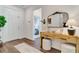 Bright foyer features wood floors, white walls, stylish console table with decor, and access to bedroom at 2335 Green Symphony Pl, Oviedo, FL 32765