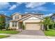 Charming two-story home with manicured lawn, paver driveway, and attached two car garage at 2335 Green Symphony Pl, Oviedo, FL 32765