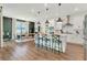 Modern eat-in kitchen with white cabinets, stainless steel appliances, and an island with bar seating at 2335 Green Symphony Pl, Oviedo, FL 32765