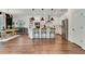Bright, eat-in kitchen boasts stainless appliances, white cabinets, pendant lighting, and hardwood floors at 2335 Green Symphony Pl, Oviedo, FL 32765